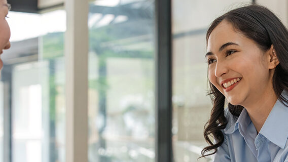 A businesswoman greets a client.