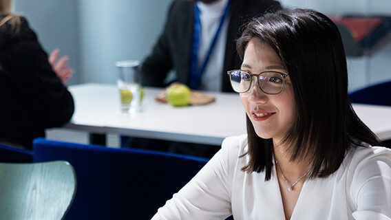 A Standard Chartered colleague speaks with a client about sustainable finance.
