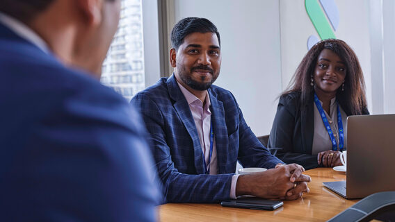 Three people discussing in a meeting