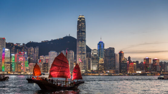 Traditional junk boat sailing across Victoria Harbour, Hong Kong.