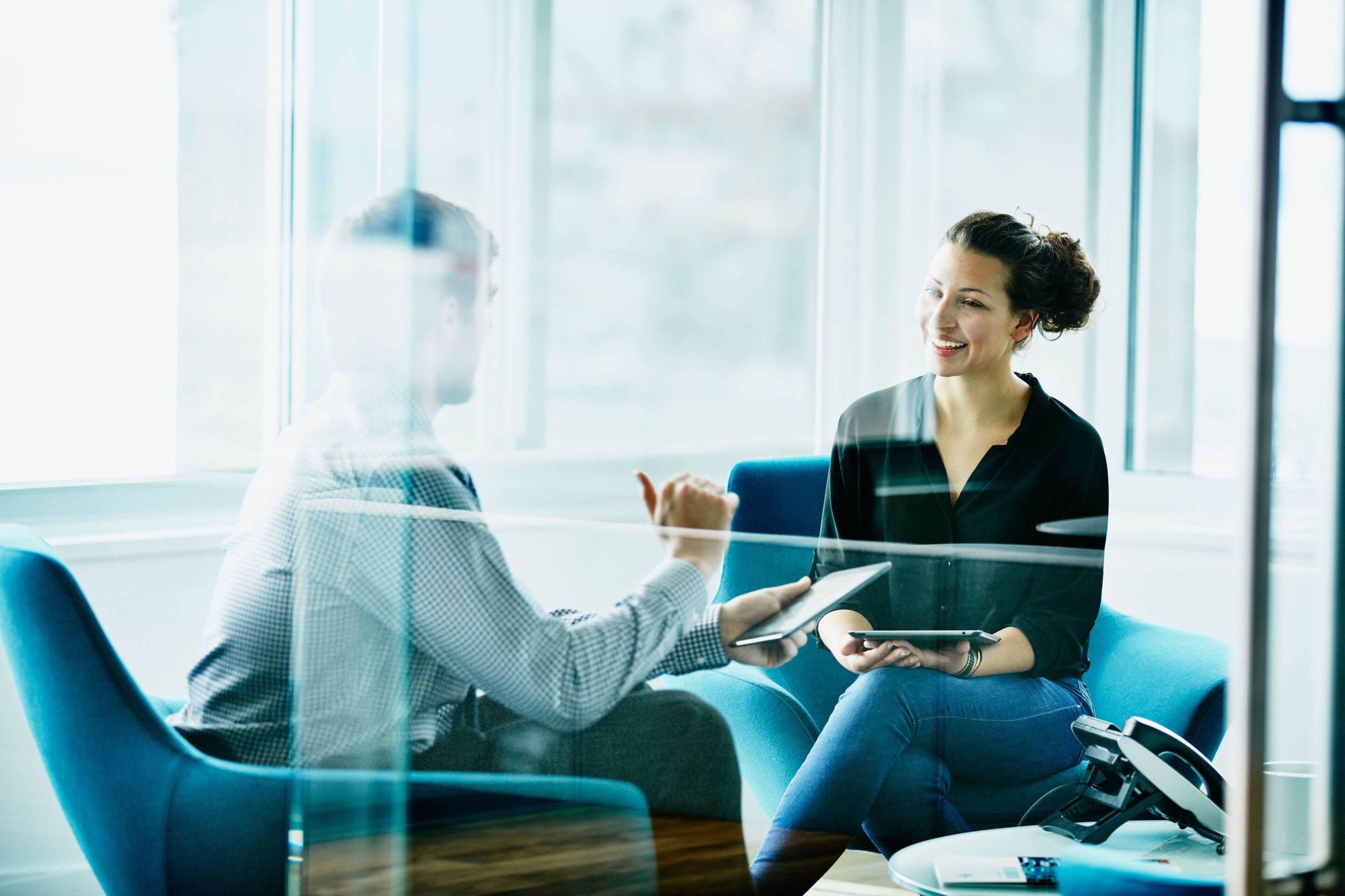 Two people discussing in a meeting room