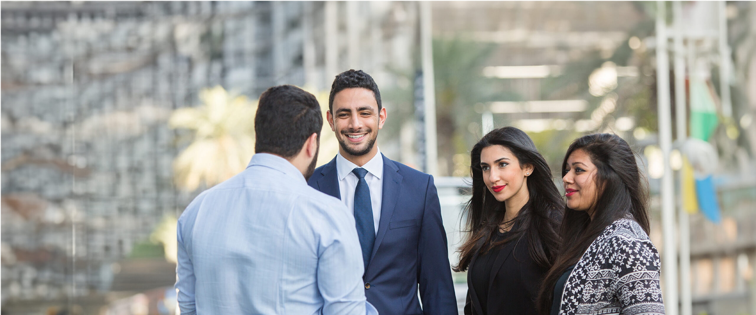 Group chatting outdoors about media