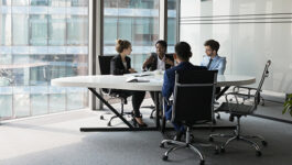 Colleagues work together in a meeting room.