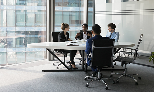 Colleagues work together in a meeting room.