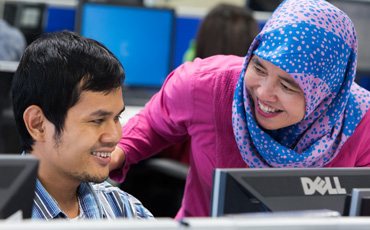 Employee and blind colleague working together