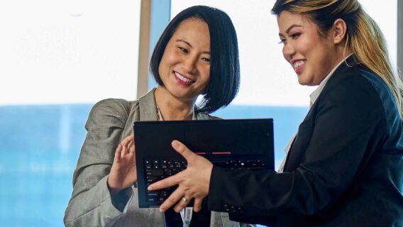 two women looking at a laptop