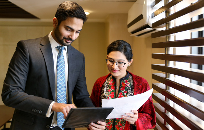 Female and male colleagues working together