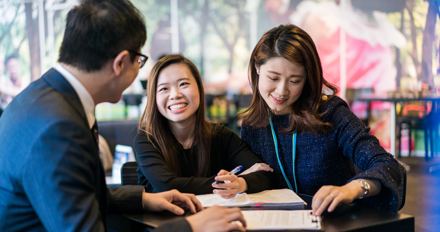 people having conversation looking at paperwork