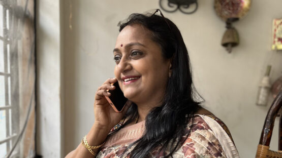 A woman in a saree talking on the phone