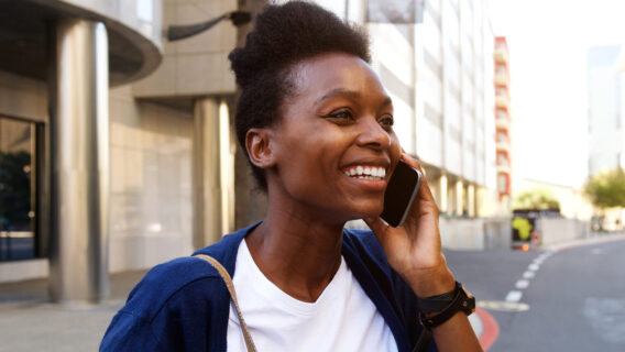 A woman cheerfully talking on phone