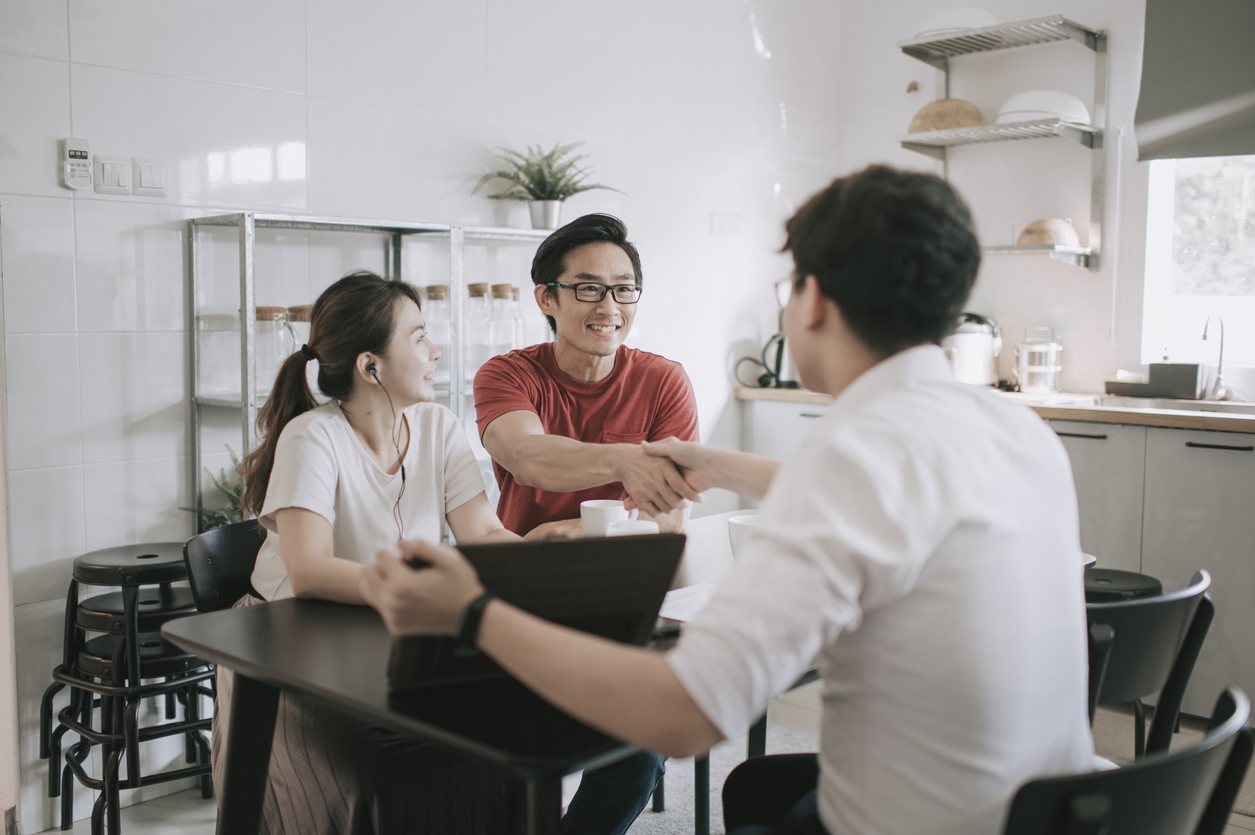 Financier shakes hands with clients