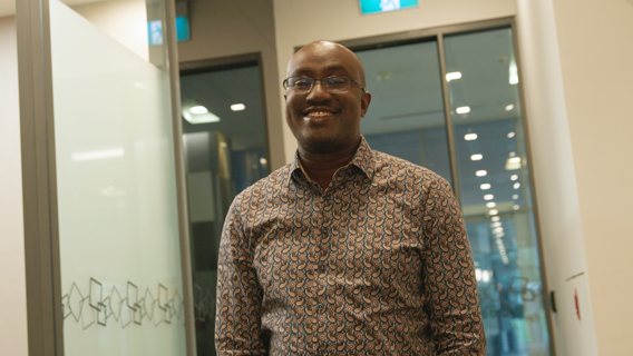 A person with glasses walking 