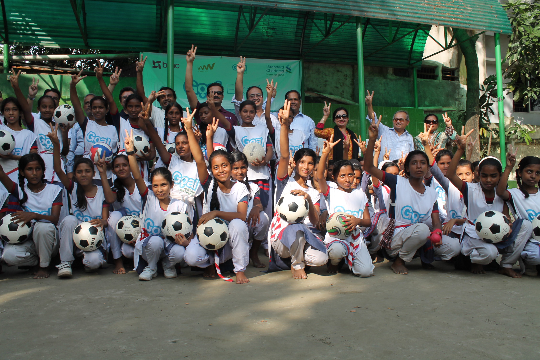 The Bangladesh Goal team show the peace sign