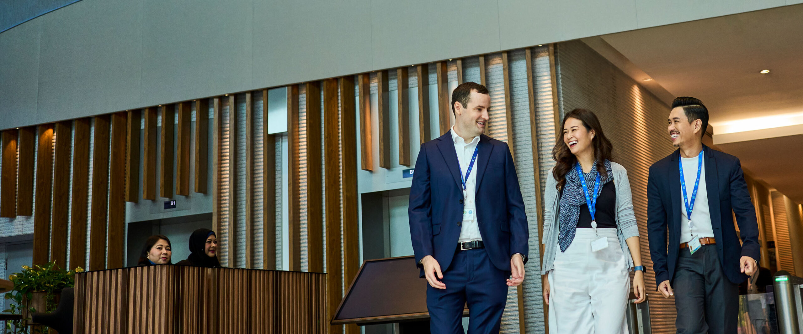 Two women walk outside a Standard Chartered office