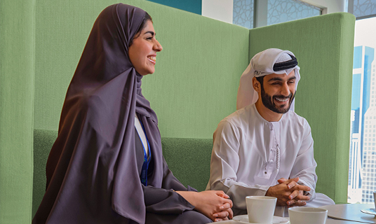 Two colleagues meet for a coffee in our downtown office, UAE.