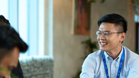 A young man in a blue shirt in an office.