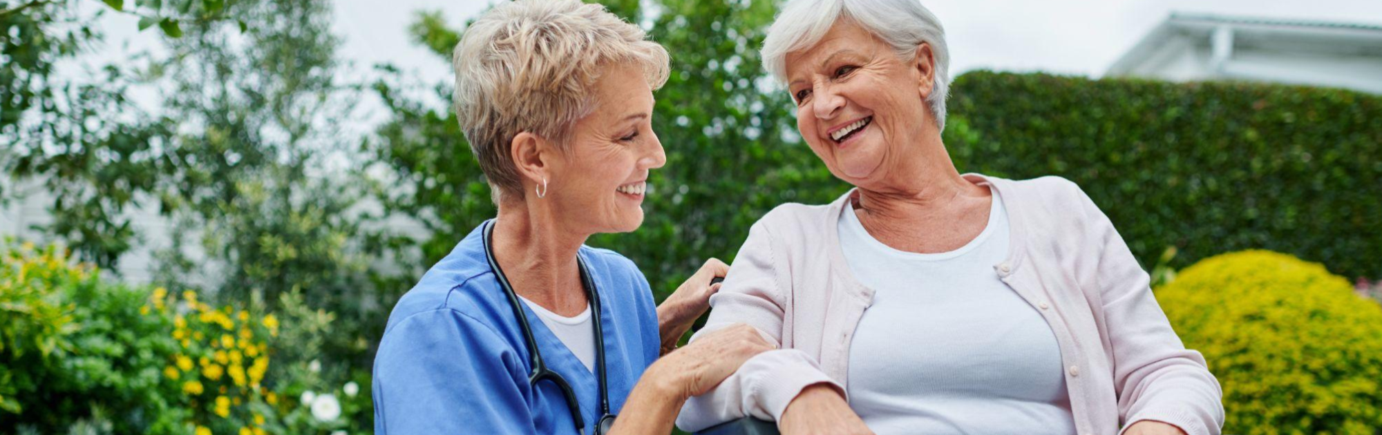 two women with short hair smiling
