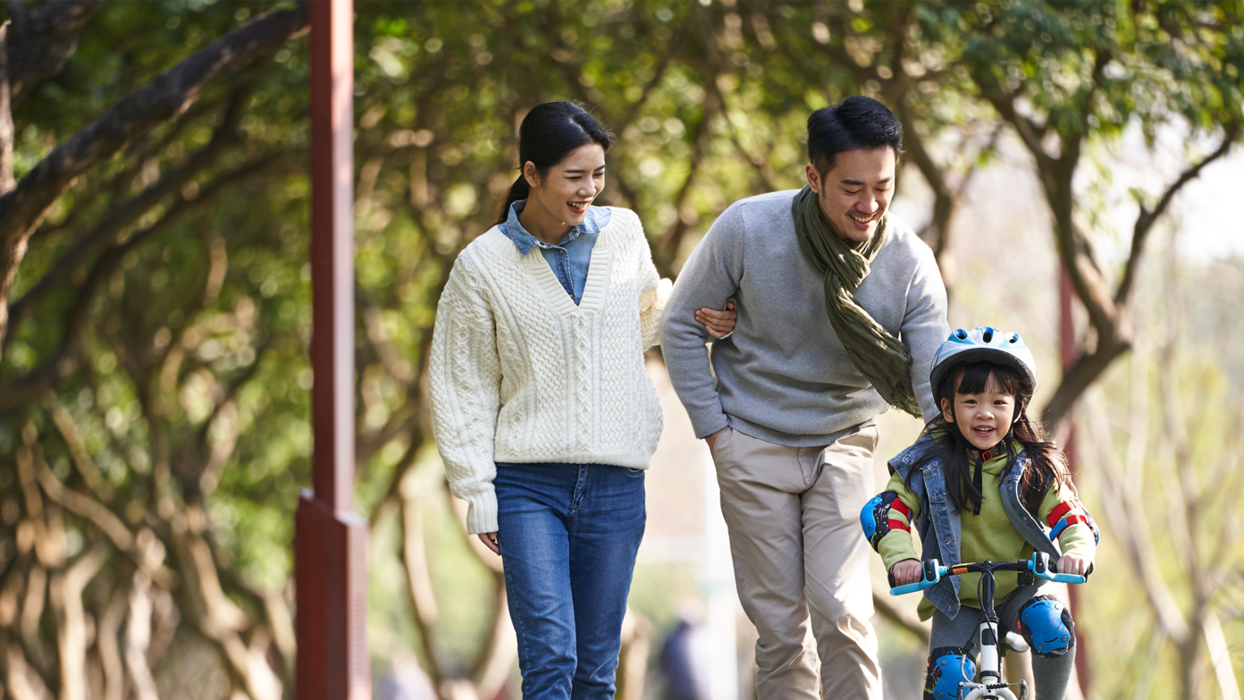 A family spend time together in a park.